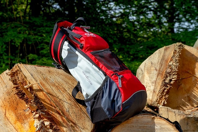 a big backpack resting on a rock