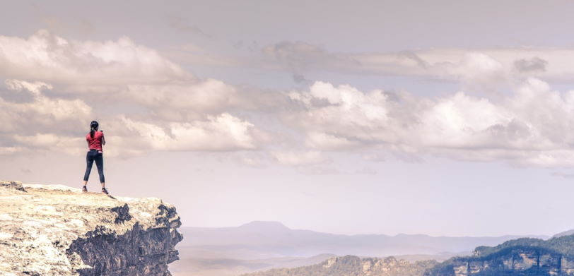 Girl on a cliff hiking in winter